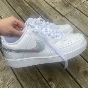 White Nike Air Force 1s with silver detailing. Size women’s 7.5.